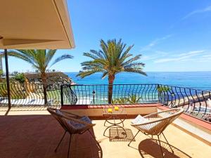 a balcony with a table and chairs and the ocean at Sea Views Benidorm Beach in Benidorm