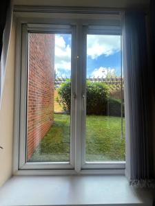 an open window with a view of a yard at Shared Room in Ashton under Lyne