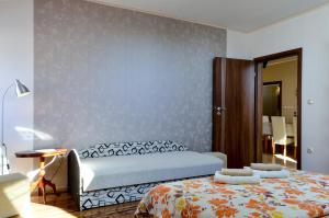 A bed or beds in a room at Harmónia Apartmanház