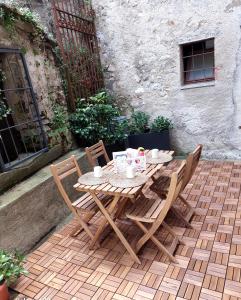 a wooden table and chairs on a patio at La Chicca Maison in Vercurago