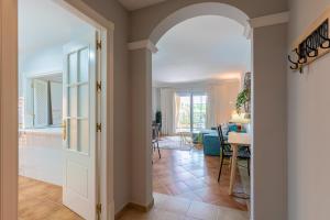 a hallway with an archway leading to a dining room at LA QUINTA ISLA CANELA GOLF by MSHOLIDAYS in Isla Canela