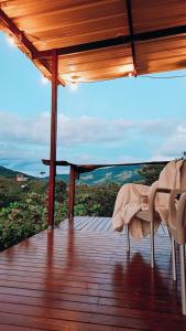 a wooden deck with a table and an umbrella at EcoCamp - San Carlos Cabine Home in San Carlos