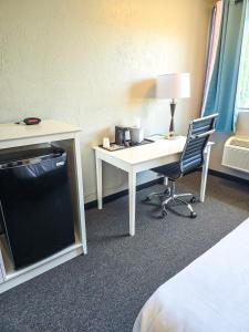 a room with a desk and a chair and a computer at Heritage House Inn in Hyannis