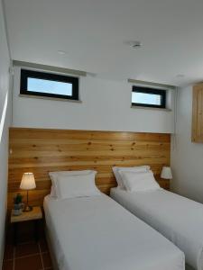 two beds sitting next to each other in a bedroom at Moinho do Duque in Runa +37 photos