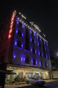 a hotel with purple lights on the side of it at Best Trip Serviced Apartments in Jeddah