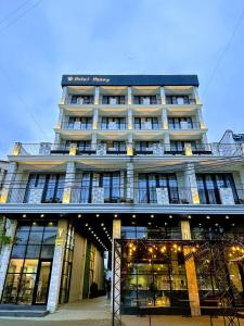 a large building with a lot of windows at Hotel Homey Kobuleti in K'obulet'i