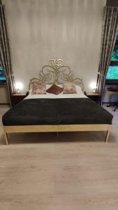 a bedroom with a bed with a black comforter at Villa Giordana in Casalborgone +45 photos