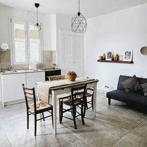 a kitchen and living room with a table and chairs at Nel Borgo di San Francesco - Casa vacanze in centro in Villa Santa Maria