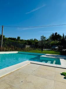 a swimming pool in a yard with aphalt at La casa delle fragole in Marotta +12 photos
