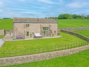 an aerial view of a stone house in a field at Crane Field Laithe in Airton