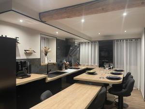 a kitchen with a table and a dining room at Pyrenair location Maison 8 personnes proche des télécabines in Luchon