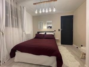 a bedroom with a large bed and a black door at Pyrenair location Maison 8 personnes proche des télécabines in Luchon +20 photos