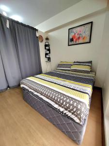 two twin beds in a room with a window at Casa Concha by Celandine private residences in Manila