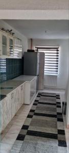 an empty kitchen with a refrigerator and a window at Apartman Dženix in Sarajevo +8 photos