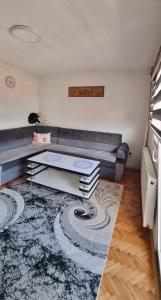 a living room with a couch and a table at Apartman Dženix in Sarajevo