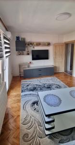 a living room with a large room with a tv at Apartman Dženix in Sarajevo