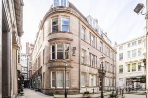 a large brick building on a city street at Tune Hotel Liverpool in Liverpool