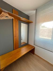 a room with a wooden shelf and a mirror at Apartamentos A Xunqueira in Redondela +16 photos