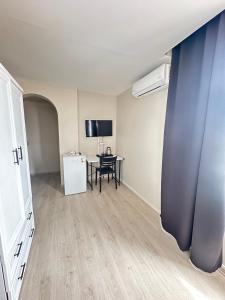 an empty room with a table and a white refrigerator at GLR OTEL in Balıkesir