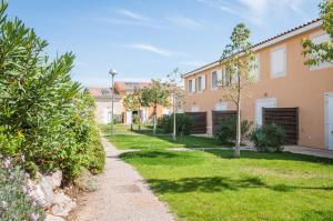 una fila di case con erba e alberi di Vacancéole - Les Demeures Torrellanes - Saint-Cyprien a Saint-Cyprien