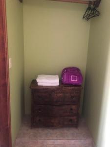 a purple bag sitting on top of a dresser in a room at Casa Hotel Descanso Real in Paipa