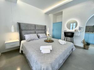 1 dormitorio con 1 cama grande y toallas. en Alykes Studios & Suites, en Agios Prokopios