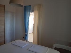 a bedroom with a bed with two towels on it at Apartment Oasis - Novalja in Novalja