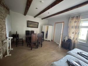 a room with a bed and a table and chairs at Haapsalu Guesthouse in Haapsalu