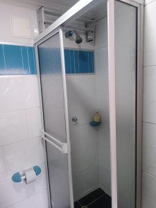 a shower with a glass door in a bathroom at Hotel Najjez in Villavicencio