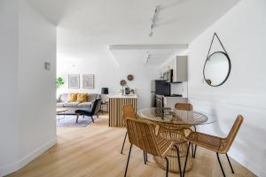 a living room with a glass table and chairs at a fully renovated condo near village centre with MT view and close to lift in Cascade lodge in Whistler