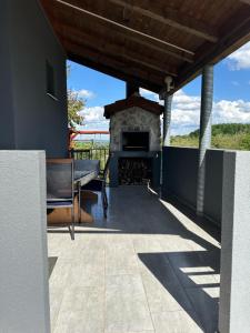 a patio with a fireplace and a table at Kuca za odmor Mare in Sveti Martin na Muri