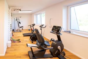 a gym with several treadmills and exercise bikes at Ferienwohnungen - barrierefrei - im sanierten Gutshof in Lalendorf