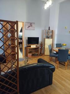 a living room with a black couch and a table at Apartment K&M in Senj