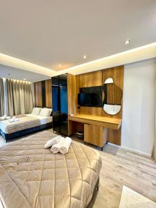 a large bedroom with two beds and a television at Hotel Joni in Ksamil