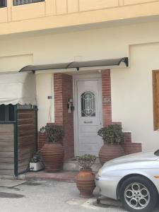 a white car parked in front of a house at Safe & Cool Apartment in Heraklio Town