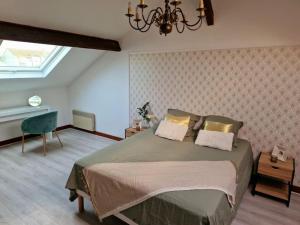 a bedroom with a large bed and a chandelier at Grande maison en Bords de Marne - 25 min de Paris in Créteil