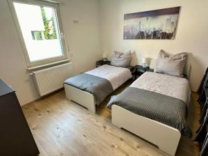 a room with two beds and a window at Rhein Quartier - Biebesheim in Biebesheim