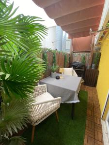 a patio with a table and chairs and plants at Studios with Mezzanine Rua da Moeda in Lisbon