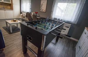 a room with a foosball table in a room with at Kuća za odmor 204 jezero Šoderica in Legrad