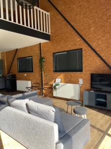 a living room with a couch and a tv at loods 14 in Groningen