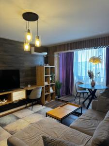 a living room with a couch and a table at Lovely 2 Rooms apartment in the CENTER of the city in Bucharest