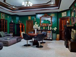 a living room with green walls and a table and chairs at Negros Haven Seaside Resort in Camanjac +43 photos
