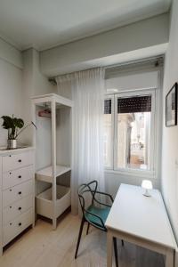 a room with a desk and a chair and a window at Blue harbour house - style meets comfort in Piraeus