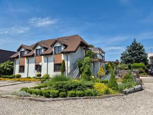 a house with a garden in front of it at Noclegi Pod Lasem in Lublin