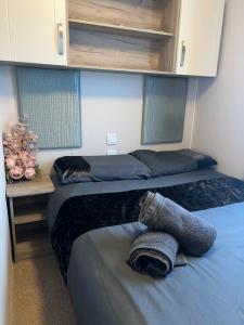 a bedroom with two beds and a desk at Skye Breaks in Sheerness