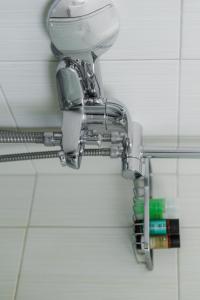 a chrome shower head on a wall in a bathroom at Studios Eliza in Livadi