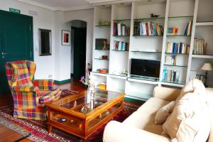 a living room with a couch and a coffee table at Apartamento en Comillas_Rovacias guest house in Comillas