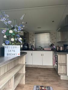 a kitchen with a sign that says us consumer style breaks at Skye Breaks in Sheerness