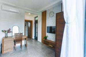 a living room with a dining table and a television at Bumax Apartments in Ulcinj