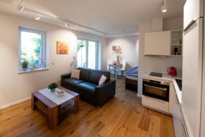 a living room with a couch and a table at Ferienwohnungen - barrierefrei - im sanierten Gutshof in Lalendorf